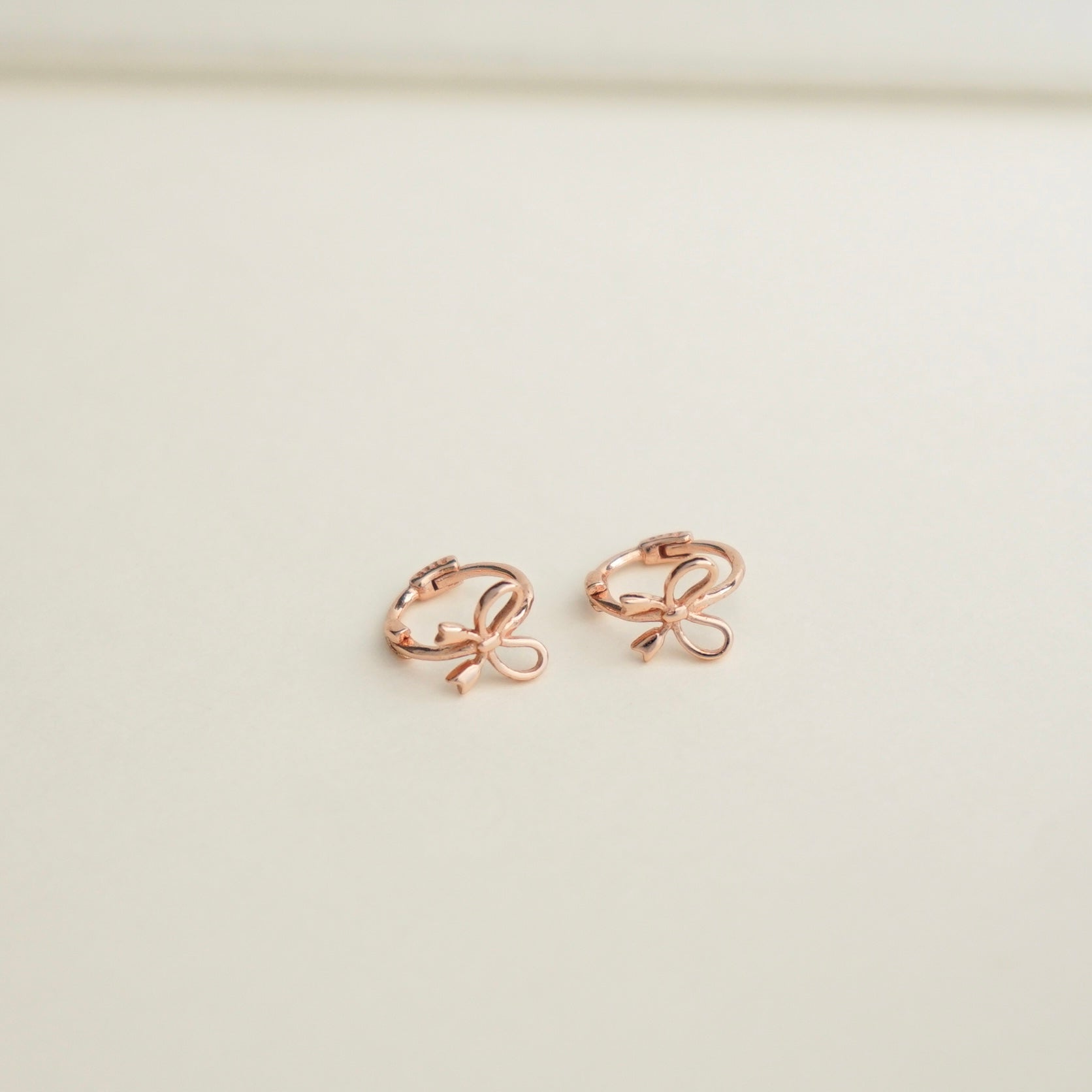 Aliyah Bow Huggie Earrings (Rose Gold)