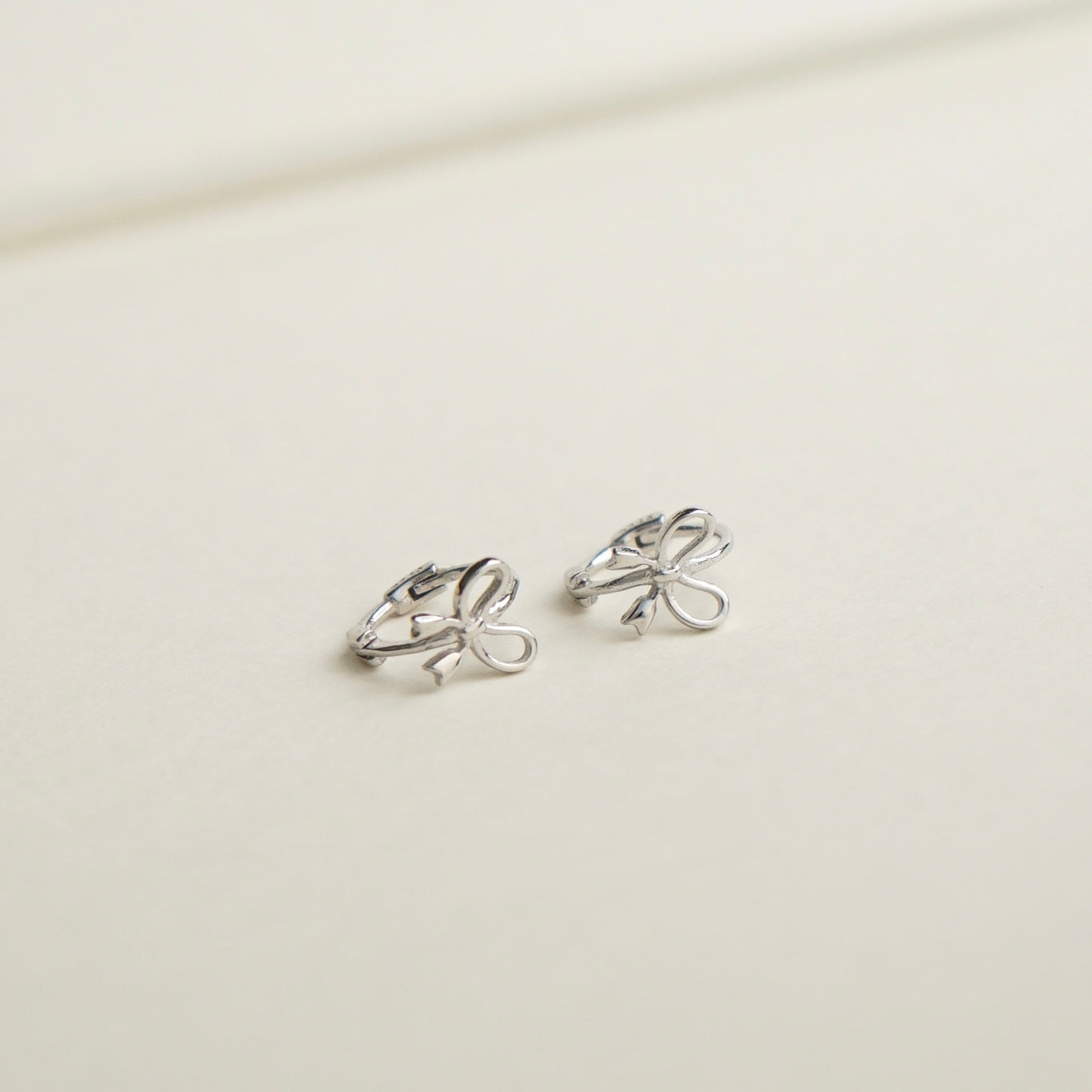 Aliyah Bow Huggie Earrings (Silver)